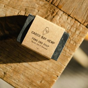 High-quality handcrafted CBD soap with vanilla oak scent on a wooden surface.